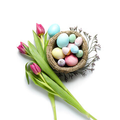Composition with nest of Easter eggs and beautiful tulip flowers on white background