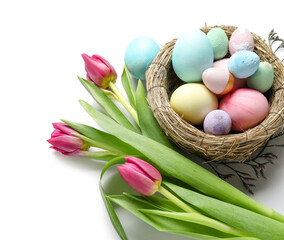 Fototapeta na wymiar Composition with nest of Easter eggs and beautiful tulip flowers on white background