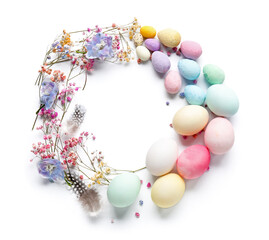 Frame made of painted Easter eggs, feathers and flowers on white background