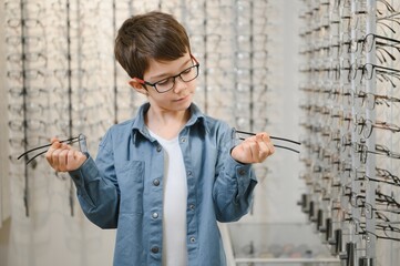 boy in glasses , at optics store