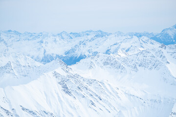 Obraz premium Beautiful panorama of snow capped mountains during sunset
