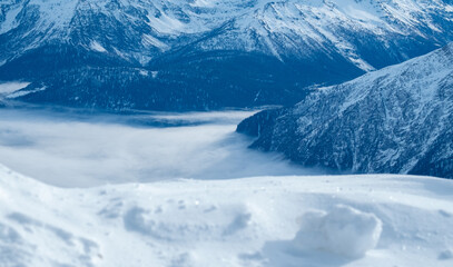 Obraz premium Mountains covered with snow and clouds. The mountains are the Italian Alps