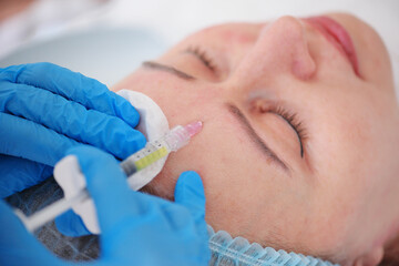 cosmetologist makes a mesotherapy or plasmolifting procedure for the patient. Biorevitalization is a method of preventing skin aging by microinjections of hyaluronic acid.