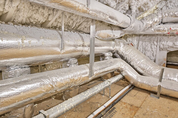 Foam insulated attic walls and flexible insulated ducts for heating and air conditioning