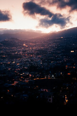 Fototapeta premium drone view of funchal night city, lights and darkness
