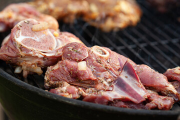 Cooking different meat on barbecue. Grilled and roasted lamb steaks on bbq