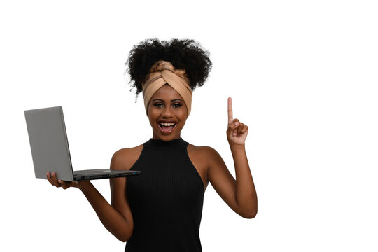 woman holding a laptop and pointing to space on the right side of the image