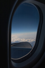 Fototapeta premium view from the window. View from the plane window of the snow-capped Alps