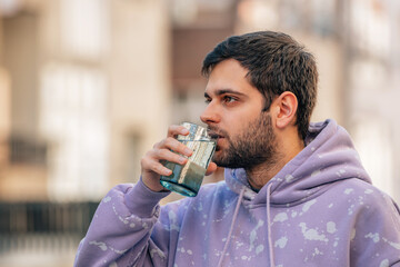 young man drinking glass of water