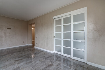 Empty house with marble floor with white French doors