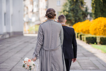 The boy and the girl walk holding hands. Man holding woman's hand