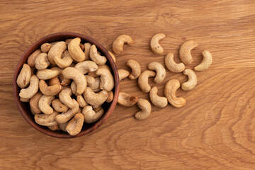 cashew nuts in bowl on wooden background