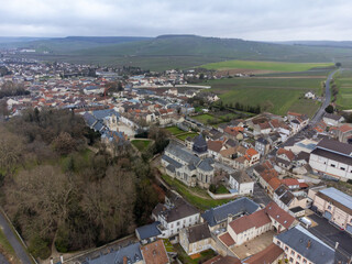 Aerial panoramic winter view on cloudy landscape, hilly vineyards and Marne river near Ay gran cru champagne village, wine production in France