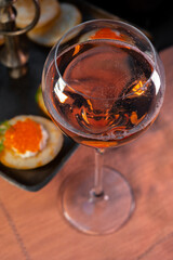 Tasting of rose brut Champagne sparkling wine with red caviar in cellars of gran cru wine house in Epernay, wine tour in Champagne, France