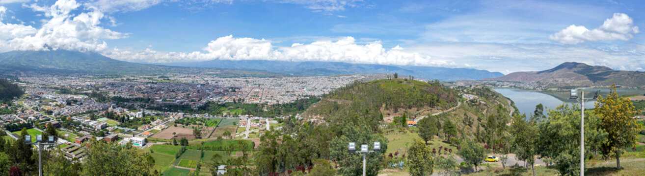 Panoramic view of the city of Ibarra, Yahuarcocha lake and surrounding Andean mountains and forests. Ibarra, Imbabura Province, Ecuador