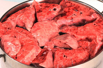 Fresh animal lungs in a metal pot, close-up
