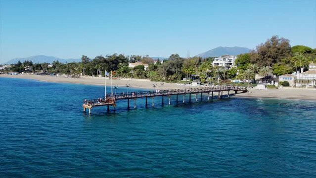 Scenic aerial views of Marbella Club pier, golden mile coastline and La Concha mountain