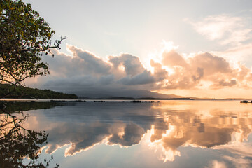 Beautiful water reflection with cloudy sky from golden hour in a beach from puerto rico