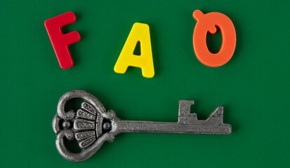 FAQ - the word is circled in multi-colored letters on a green background with a key