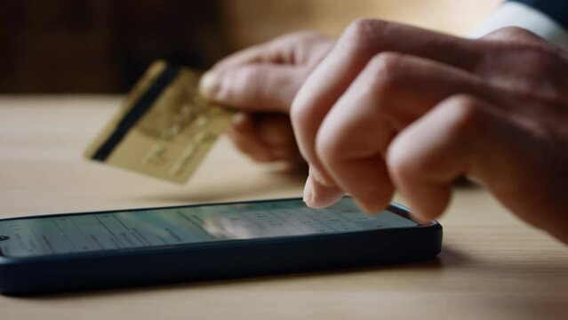 Hand entering card number in mobile app for online purchase close up. E-commerce