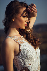 Portrait of a young woman in a white dress