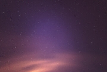 Fototapeta na wymiar Night sky with purple theme and orange clouds