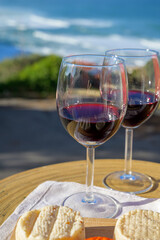 Food and wine pairing, red dry Portuguese wine and variety of goat, sheep, cow cheeses made with paprika, herbs in Portugal
