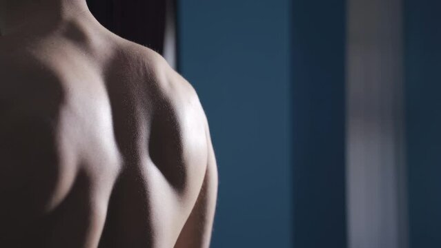 Man working out at home using dumbbells to develop wing muscles.
Young athlete man is working regularly at home to develop and enlarge his wing and back muscles.
