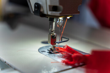 tailor sews fabric for clothing on a sewing machine