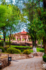 beautiful park with kiosk in the background, with green trees in foreground, sierra de alicia park in zacatecas downtown