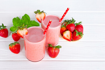 Strawberry yogurt fruit juice smoothie pink colorful fruit juice milkshake blend beverage healthy high protein the taste yummy In glass drink episode morning on wood background.