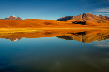 Salt lake Lejia reflection, idyllic volcanic landscape at Sunset, Atacama, Chile