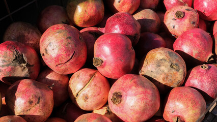 Pile of freshly picked delicious pomegranate fruit, red, ripe, healthy and ready to eat