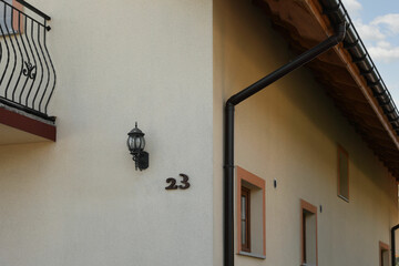 Fototapeta premium Number 23 on yellow house with balconies outdoors