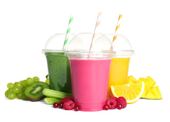 Plastic cups with delicious smoothies and ingredients on white background