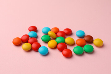 Tasty colorful and sweet candies on pink background