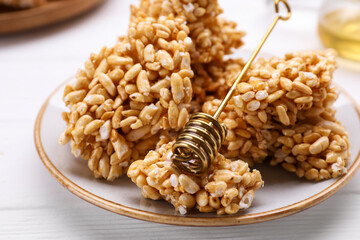 Puffed rice bars (kozinaki) on white plate, closeup