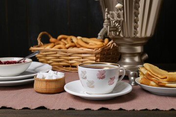 Aromatic tea, traditional Russian samovar and treats on table