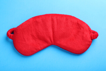 Soft sleep mask on light blue background, top view