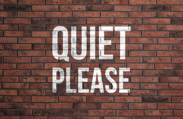 Phrase Quiet Please on red brick wall
