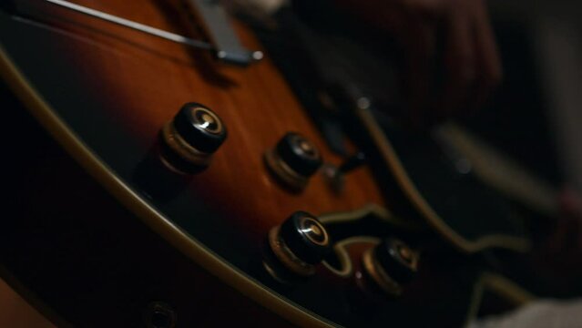 close up of a person playing a gibson guitar