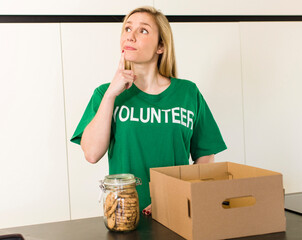 young adult pretty blonde woman. volunteer and donation concept