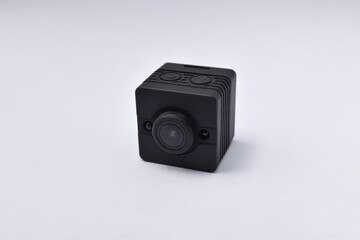 Black security camera isolated on white background. Mini spy camera