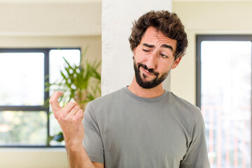 young adult crazy man with expressive pose at a modern house interior