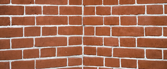 Minimal fragment of brick wall angle close up. Beautiful minimalist brick texture backdrop. Geometric and symmetrical background of brick wall pattern. Modern design of interior or exterior close-up.