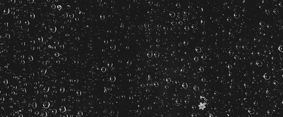 Atmospheric minimal grayscale backdrop with rain droplets on glass. Wet window with rainy drops and dirt spots closeup. Blurry minimalist monochrome background of dirty window glass with raindrops.