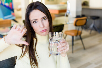 young adult woman with a water glass