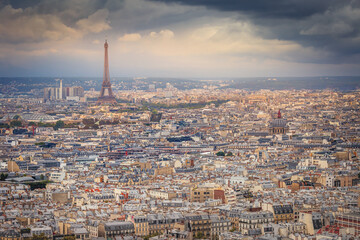 Paris skyline at sunset with Eiffel Tower above parisien roofs, Paris, France