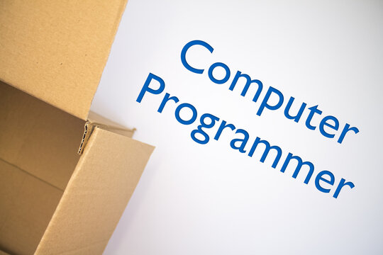 Computer Programmer word with cardboard box. Brown folded card box.