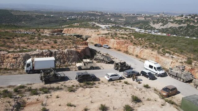 Israel Army Squad Soldiers On Humvee Vehicles Driving Through Training Ground Country Road, Aerial Tracking Shot